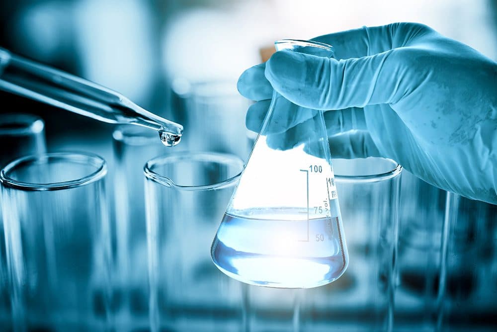 Profissional realizando análise de amostra em laboratório de controle de qualidade